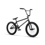 The Wethepeople Revolver 20 Inch Bike is a black BMX with thick tires and a sturdy frame, equipped with high-end components, displayed at an angle against a white background.