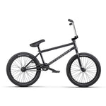 The Wethepeople Trust 20 Inch Cassette Bike, with "WETHEPEOPLE" on the frame, features a sleek black design with a padded seat and handlebars. Its freecoaster hub enhances every ride. Sturdy black wheels and spokes make it perfect for biking enthusiasts.