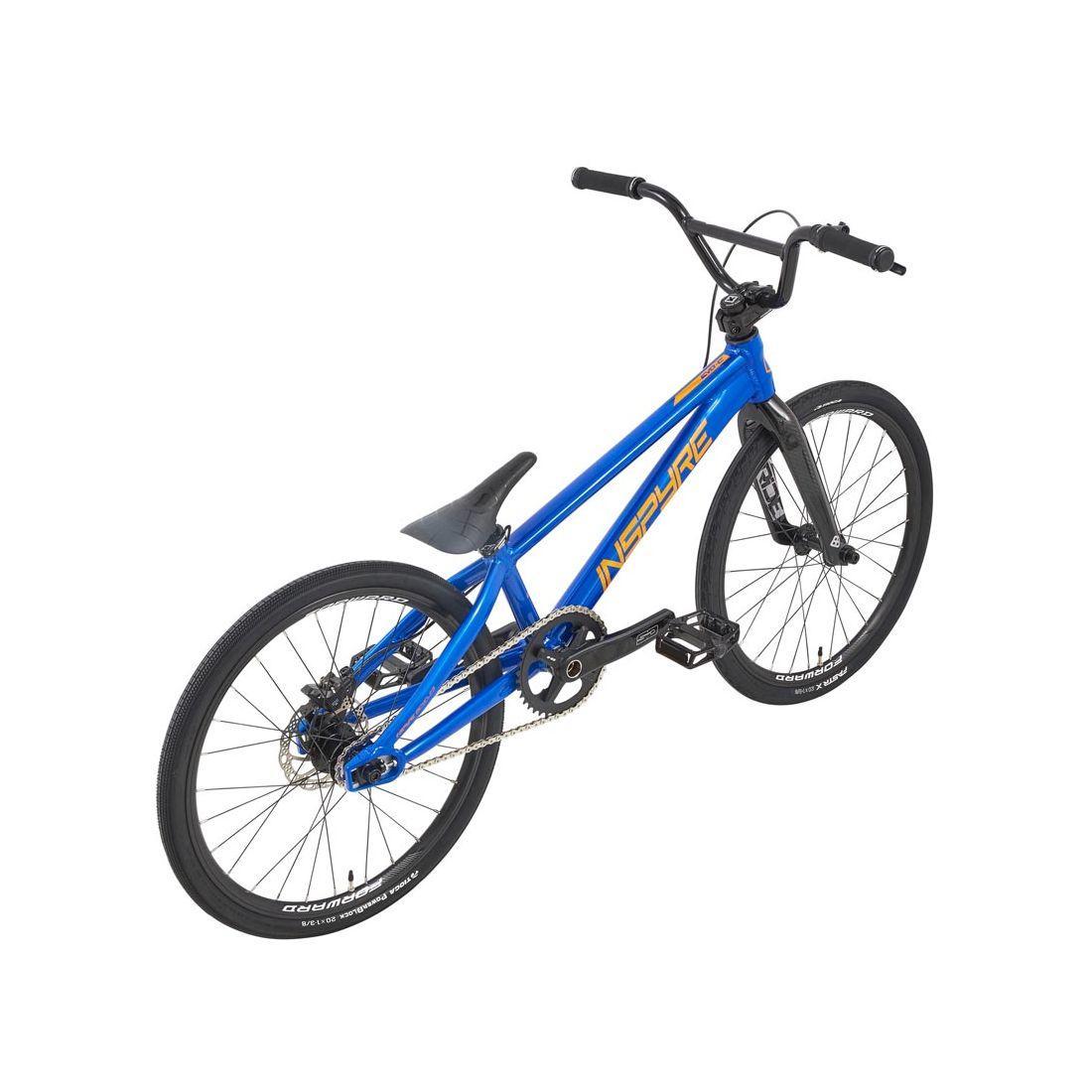 The Inspyre Evo-C Disc Expert XL Bike 2026 is a blue BMX-style bike with black handlebars, seat, and tires, featuring race geometry, shown from a rear-side angle against a white background.