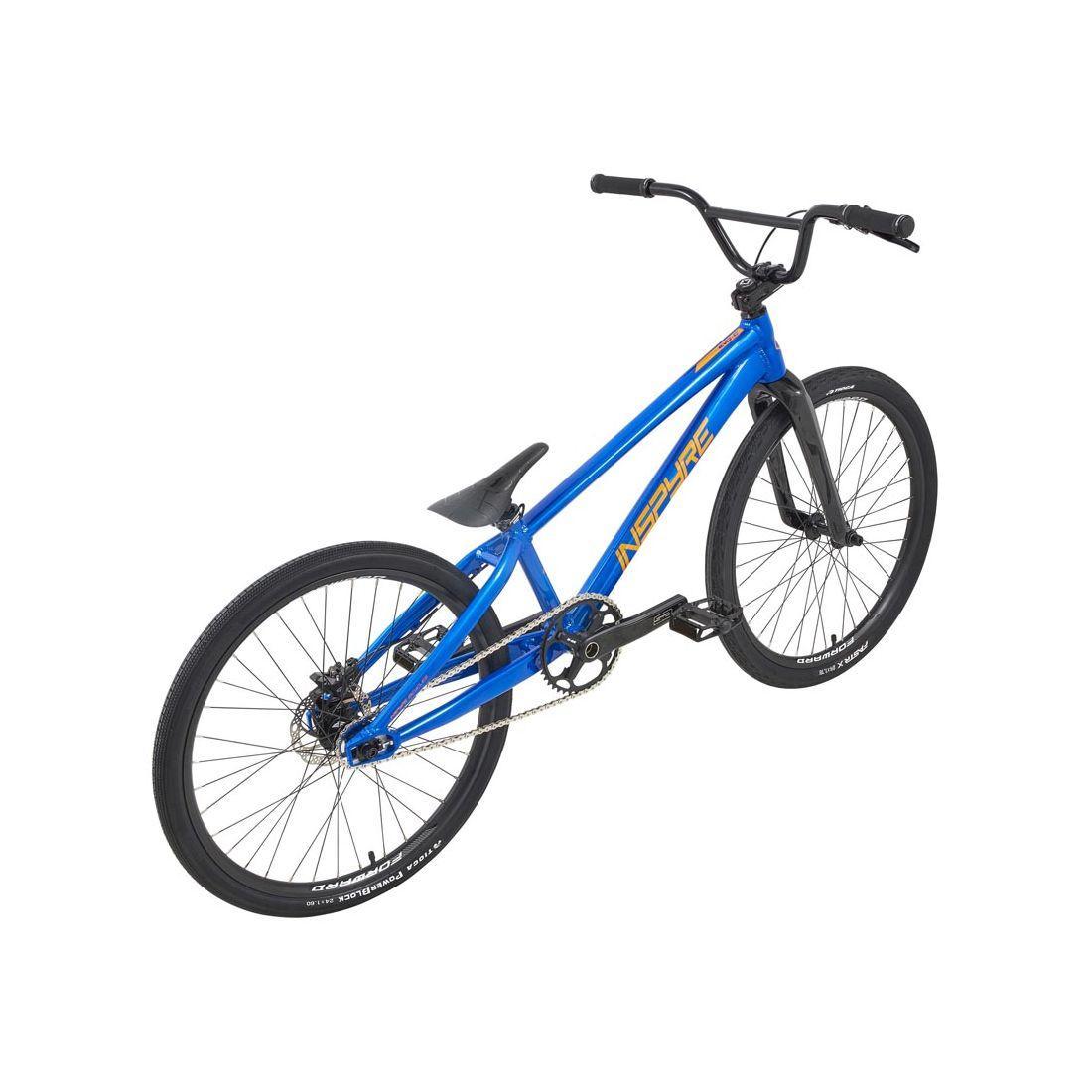 The Inspyre Evo-C Disc Pro Cruiser Bike 2026 is a blue BMX race bike with black handlebars, saddle, and tires, shown from a rear-side angle on a white background. It features Shimano hydraulic disc brakes for powerful stopping.