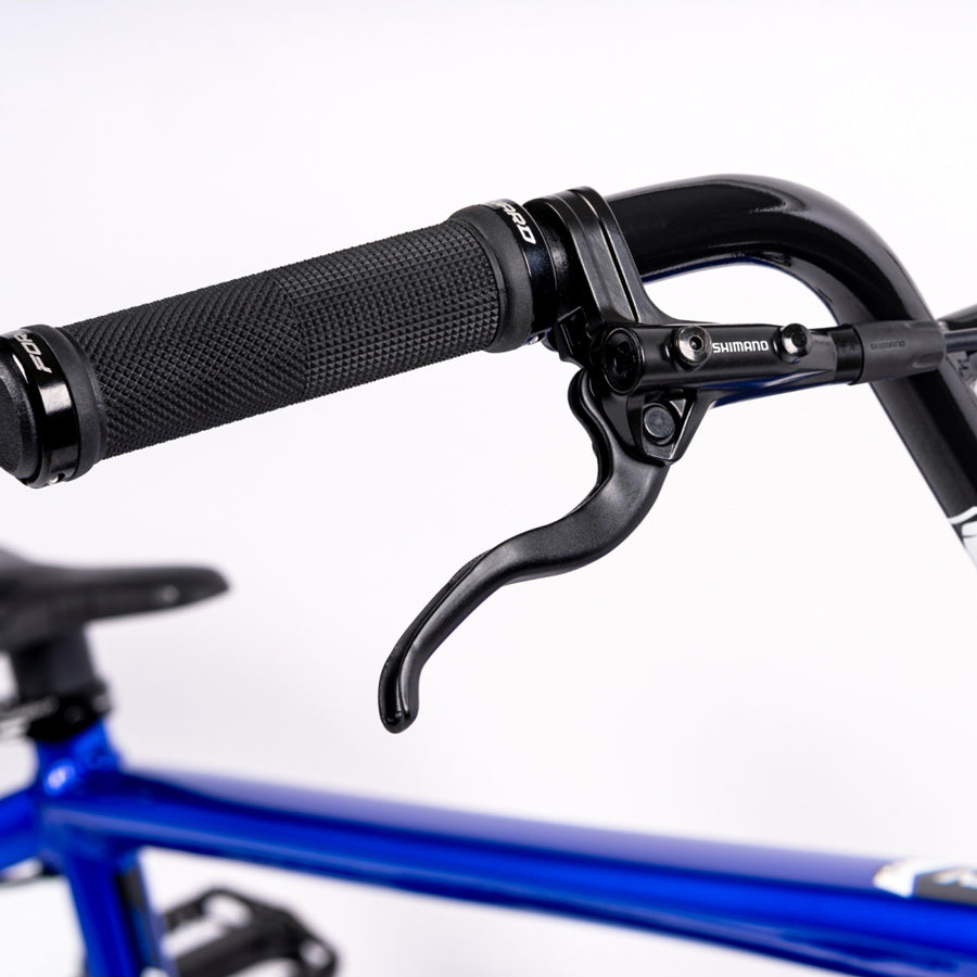 A close up of a blue handlebar on an Inspyre Evo Disc Expert XL Bike.