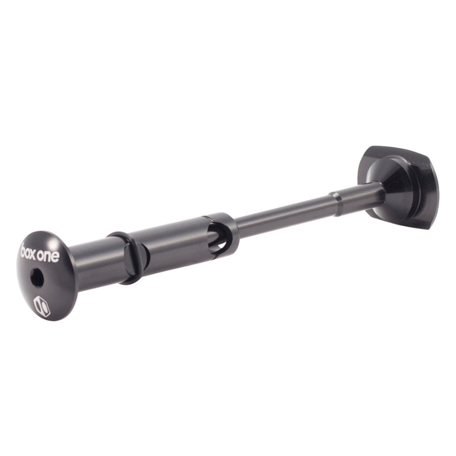 The Box One Stem Lock 1-1/8th Inch is a CNC-machined black metal bicycle axle with "box one" on the end, featuring a cylindrical shaft and hexagonal end cap for secure stem lock or steerer tube compatibility.