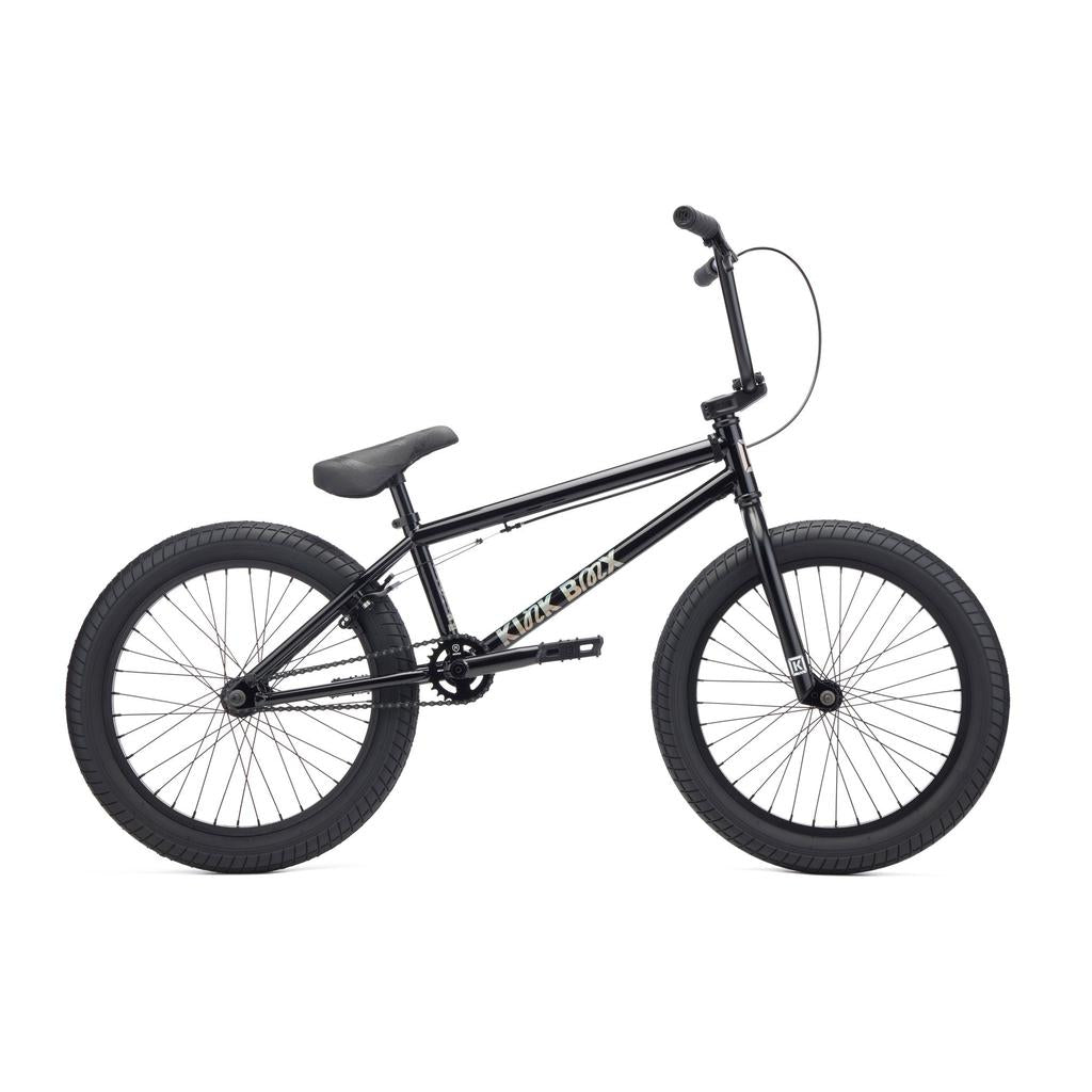 The Kink Curb 20 Inch Bike (2027) is a black beginner’s BMX with thick tires, straight top tube, Mission components, and a padded seat, pictured in profile on a white background.
