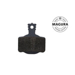Magura 7 Series MT Disc Brake Pad with a black backing and dark friction material, featuring a high-performance compound, displayed next to a circular "Magura Original Spare Parts" logo.