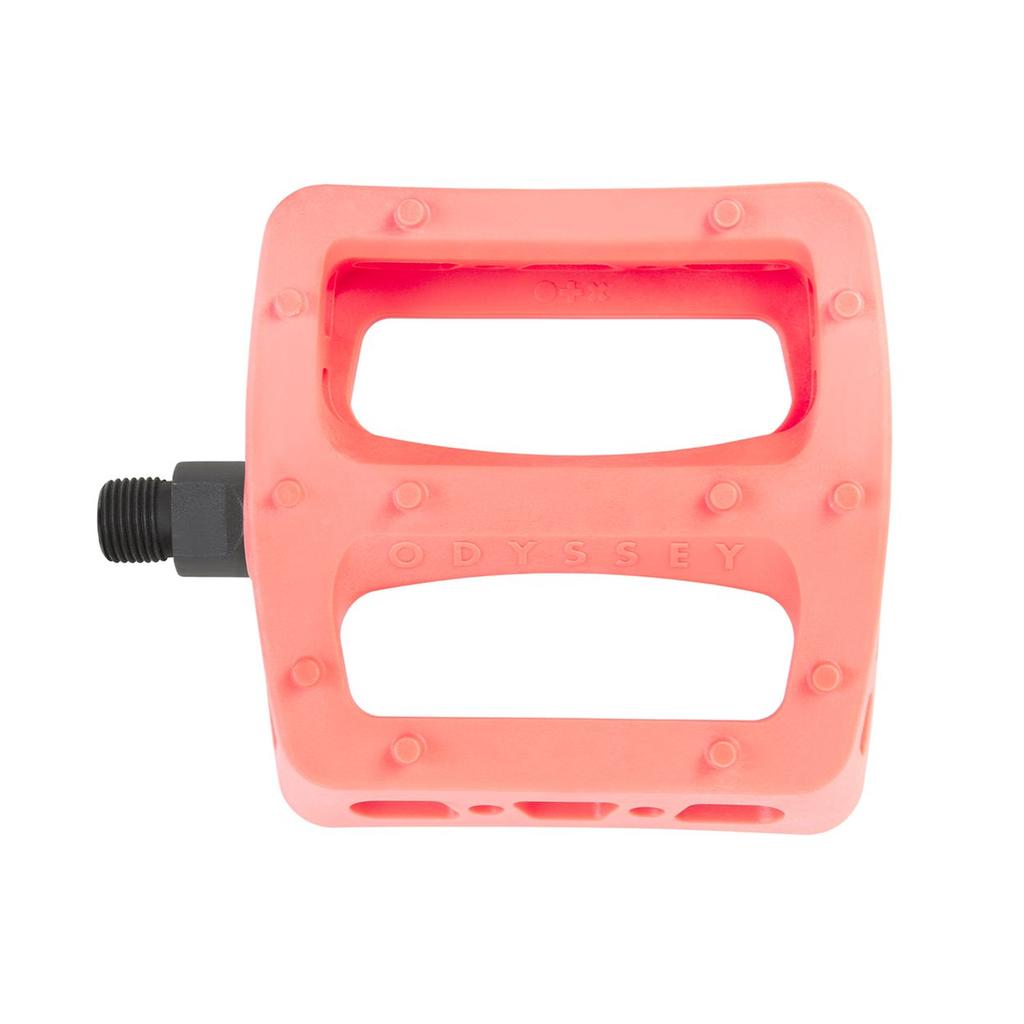 The Odyssey Twisted PC Pro Pedals in pink feature a rectangular shape, two large cutouts, a black metal spindle, and are made from durable high-strength nylon composite for both style and strength on your BMX ride.