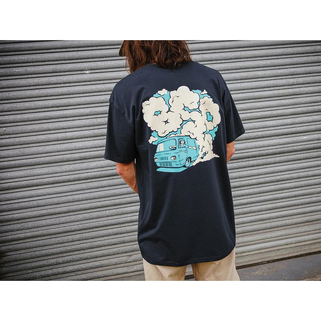 In a BSD Burnout T-Shirt, which boasts a lightweight cotton design with a cartoon print of a smoking car on the back, someone stands casually in front of a metal shutter.