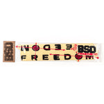 A packaged yellow headband featuring red and black text and designs, with the text reading "BSD Freedom Frame 2019 Decal Set" and showcasing arrow and target motifs. A beige and brown tag is attached.