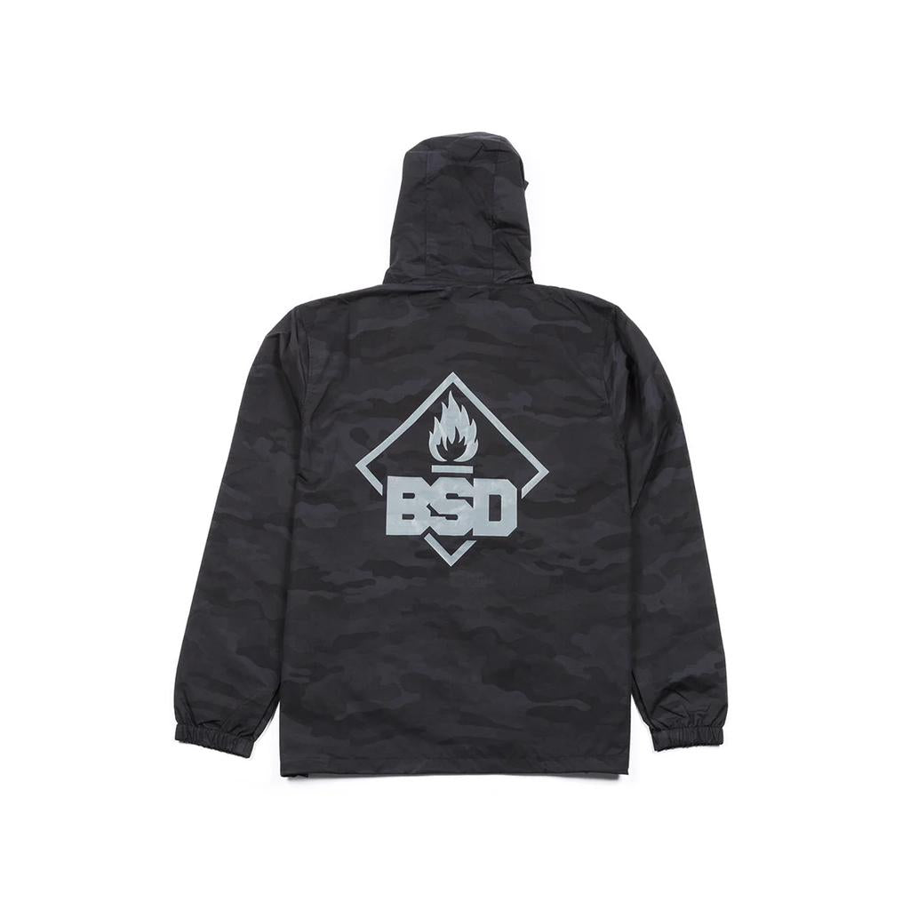 The BSD Roastin Jacket features a black camo water-resistant design with a hood and long sleeves. It has a large graphic on the back featuring "BSD" below a flame inside a rhombus.