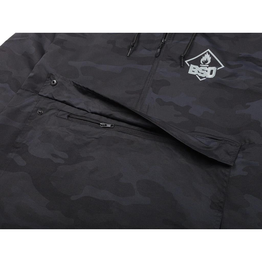The BSD Roastin Jacket is a black camo design crafted from waterproof nylon. It features a "BSD" logo on the chest, zippered pockets, and a partially visible hood, combining functionality with style.
