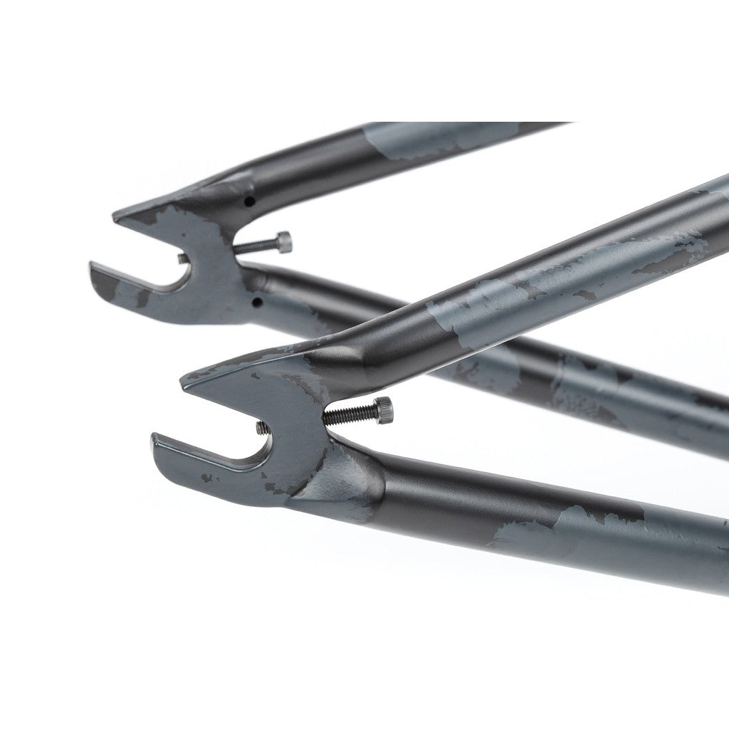 Close-up of worn-out BSD Soulja V3 Frame fork tips with invest cast dropouts, showing scratches and paint chipping, isolated on a white background.