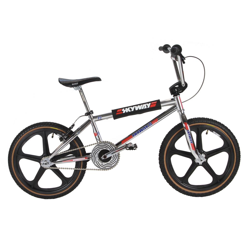The Skyway TA 20 EX Replica 20 Inch Bike (2026) features silver paint, black Tuff Wheel II mag wheels, a black seat, and red, white, and blue decals, displayed in side profile on a white background.