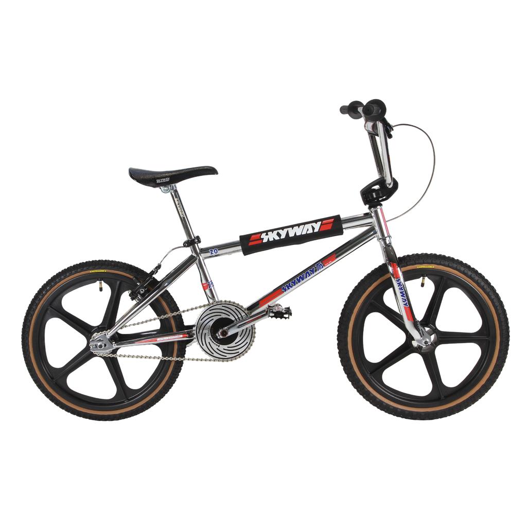 The Skyway TA 20 Replica 20 Inch Bike (2026) features a chrome frame, black Skyway Tuff wheels, Redline Flight cranks, padded top tube, and "Skyway" branding.