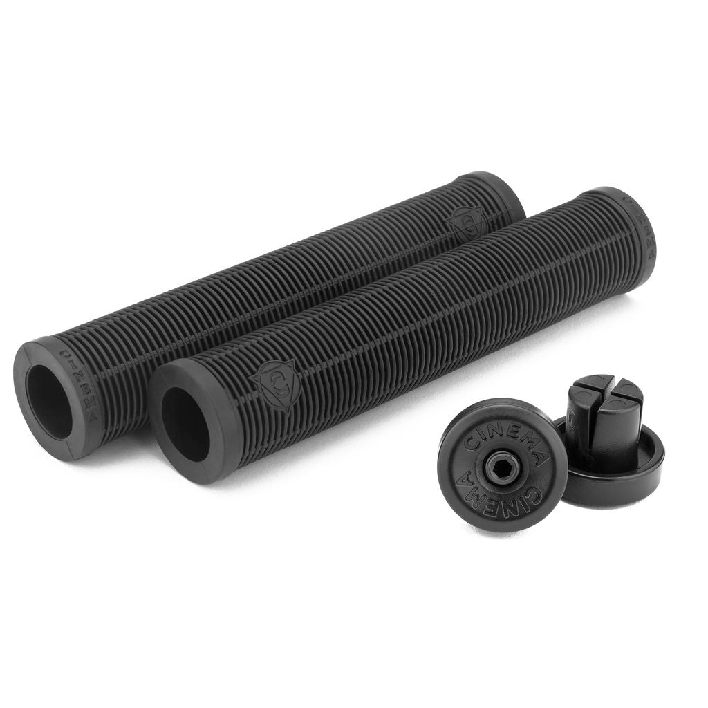 Two Cinema Garrett Reynolds grips in black, featuring a textured surface and accompanied by two end caps, displayed on a white background.