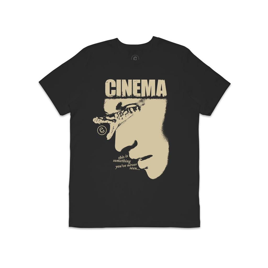 Cinema Snake Eyes T-Shirt: Vintage black with a stylized side profile face, "CINEMA" on top, and "this is something you've never seen..." below. Made from Airlume Combed Cotton for a modern look.