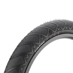 Close-up view of a black Cinema FPS Tyre BMX tyre with extra traction, featuring a textured, fast-rolling tread pattern and "CINEMA FPS" branding on the sidewall.