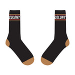 The Colony BMX Logo Socks feature a black color scheme with brown toes and heels, highlighted with the word "COLONY" and a red stripe near the top. Proudly part of the Logo Socks collection, these socks are Australian Made and ideal for any Colony BMX enthusiast.