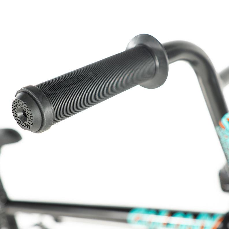 Close-up of the black handlebar with textured grip on a Colony Sweet Tooth Pro Elite 18 Inch BMX Bike, showcasing its frame with blue and orange decals.