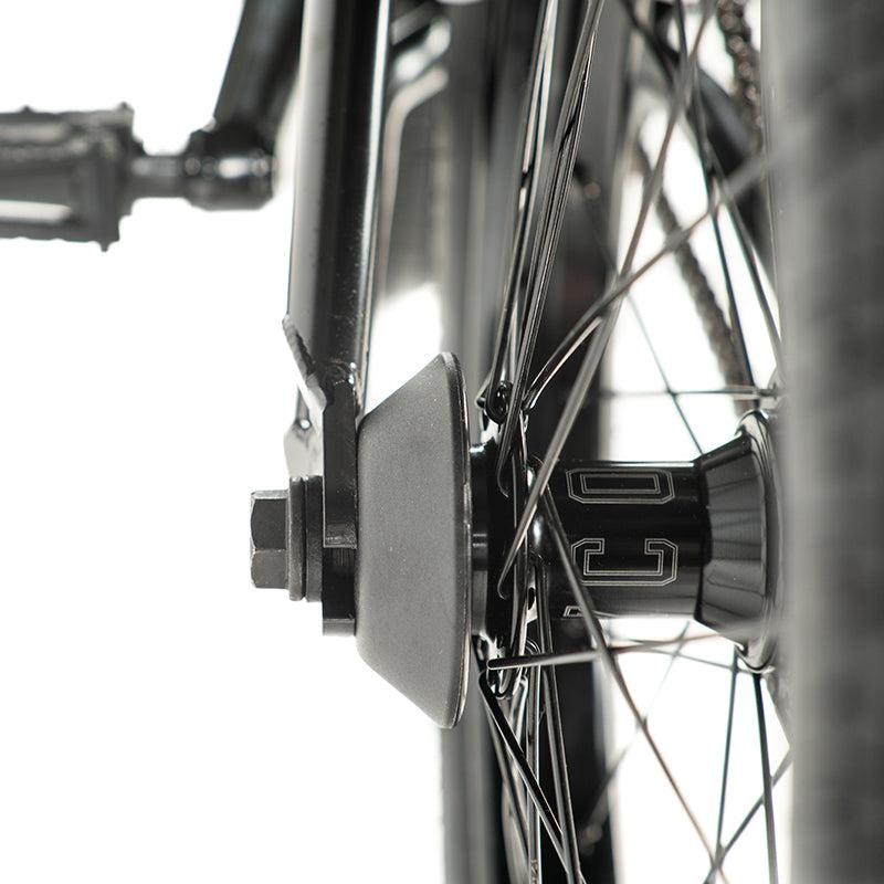 Close-up of a BMX bike's rear wheel, showcasing the hub, spokes, and frame side view. Could be a Colony Sweet Tooth Pro Elite 18 Inch BMX Bike, famed for precision-crafted components and durability.