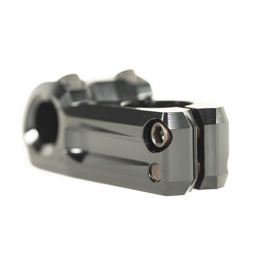 A close up image of a Colony Variant 52mm BMX Stem, a black handlebar clamp serving as a low-rise alternative to top load stems.