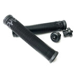 Two Cult Crew Grips in black, featuring a ribbed design with end caps and made from durable rubber, are placed diagonally on a white background.