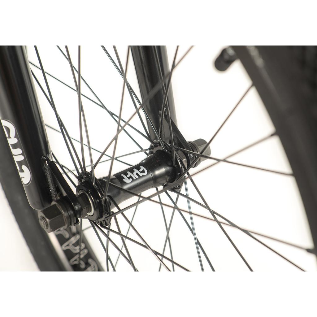 Close-up of a Cult Access 20 Inch Bike wheel highlighting its black spokes and hub, along with part of the hi-tensile frame, ideal for beginners wanting maneuverability.