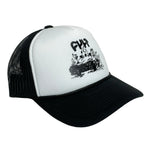 The Cult BurnItDown Trucker is a black and white hat showcasing a bold graphic of a burning car with "Cult Crew" prominently displayed on the front.
