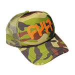The Cult Real Tree Feather Cap is a green camouflage mesh trucker hat featuring bold orange "CULT" lettering on the front and an adjustable snapback for a perfect fit.