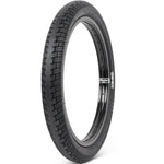 The Shadow Creeper 20 Inch Tyre, featuring a black textured tread, stands upright against a white background.