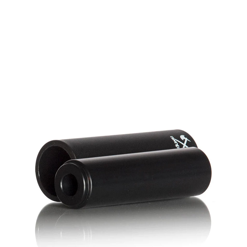 The Demolition Axes Pegs, black and cylindrical, are stylishly showcased with one open and one closed on a reflective surface.