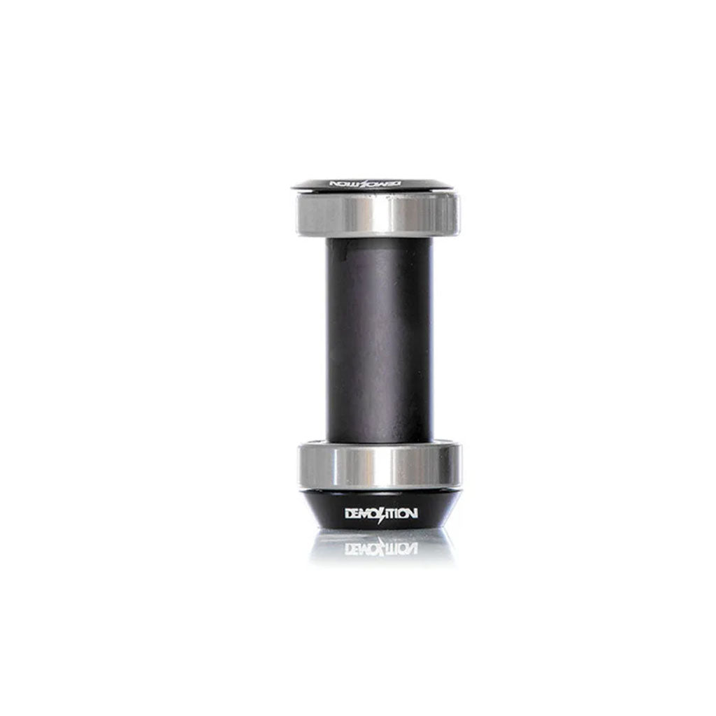 Demolition 22mm Bottom Bracket with metal and rubber components, sealed bearings, and reflective end caps, showcased vertically against a white background.