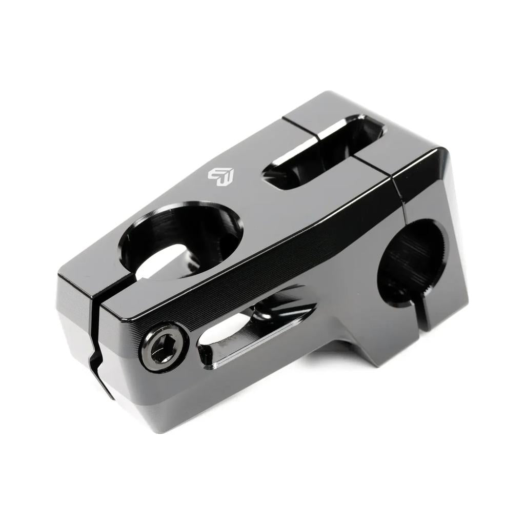 Close-up of the sleek Eclat Felix Front Load Stem, featuring a black metal finish with two cylindrical openings and a central bolt for handlebar attachment. Expertly CNC machined, this Felix Prangenberg signature model includes a robust Vice-Jaw clamping system for ultimate stability.