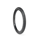 The ECLAT Mugen Flatland Tyre, known for its high performance on flatland terrains, showcases a textured tread pattern and is displayed upright against a white background.
