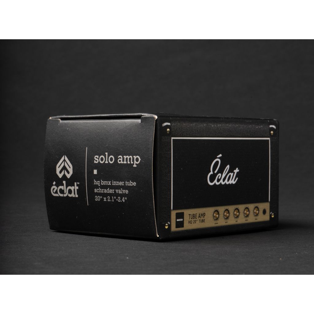 A black packaging box for the Éclat Solo SV Tube (Each) showcases product details and a decorative amplifier design, designed specifically for wider tires with a Schrader valve.
