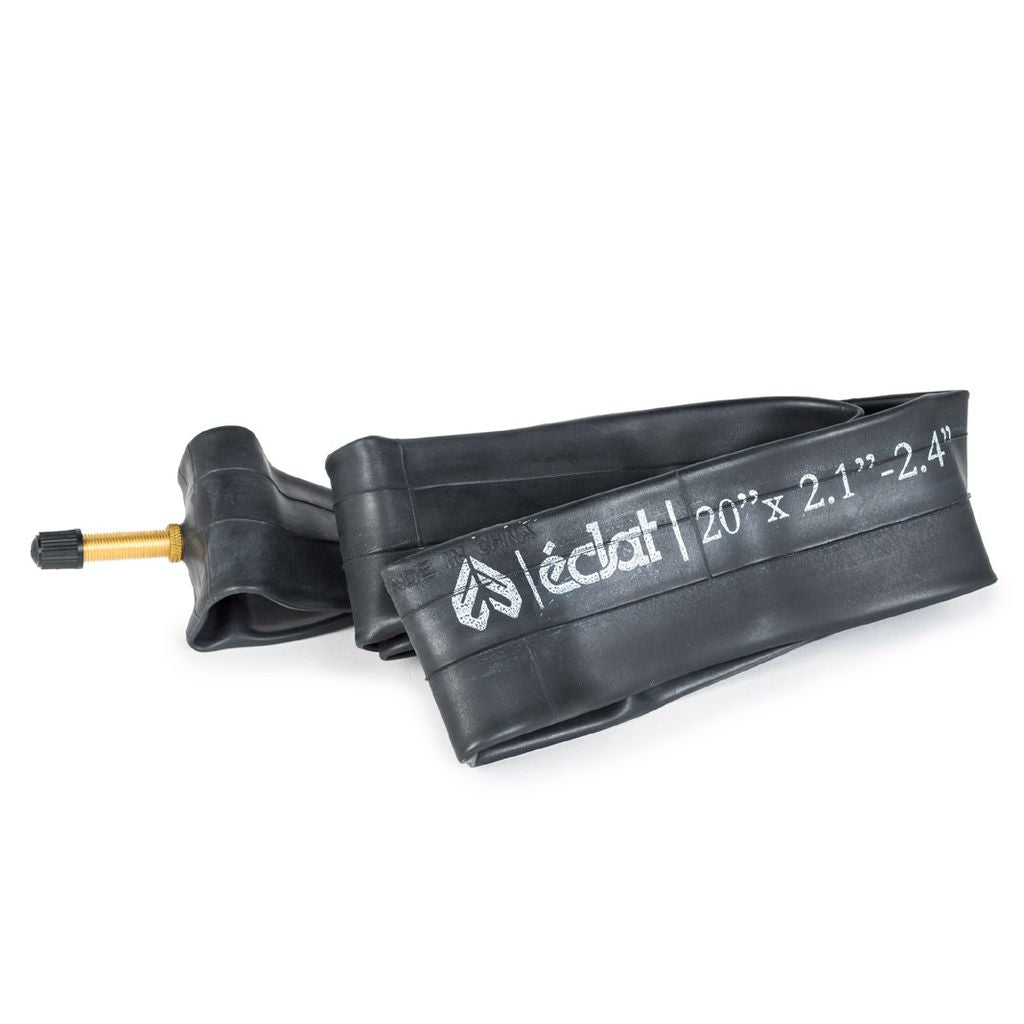 The Eclat Solo SV Tube, featuring a folded black design with a Schrader valve, is perfectly suited for wider tires and has size specifications of 20" x 2.1"-2.4".