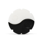 An Eclat Zen Wax divided into black and white halves, resembling a yin-yang symbol, with embossed tree-like icons on each section and an ergonomic grip for easy handling.