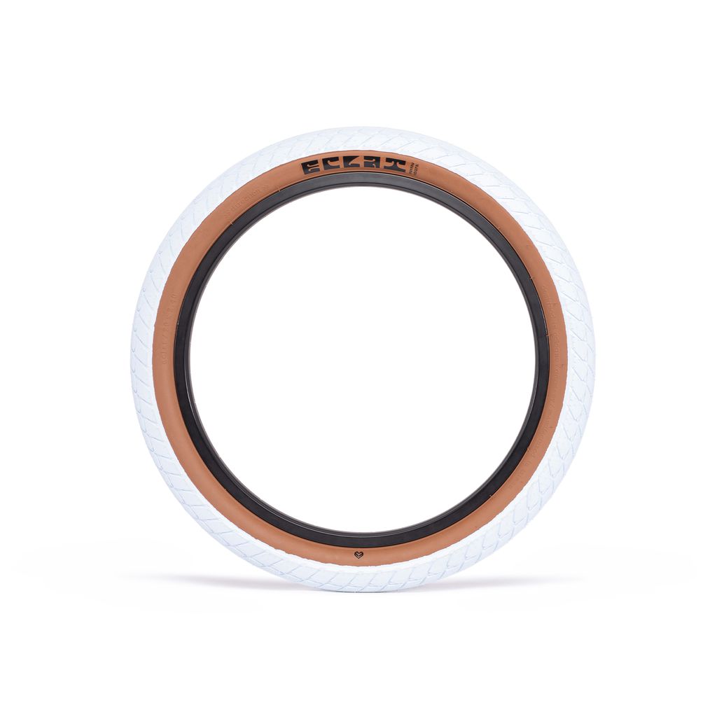 A white tire with brown rims on a white background, featuring the SEO keyword "Eclat Morrow Tyre (Each)" for a durable and versatile signature tire.
