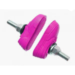 The Kool Stop X Vans Brake Pads come in pink and are shoe-shaped with threaded steel posts and metal bolts at the ends for secure installation.