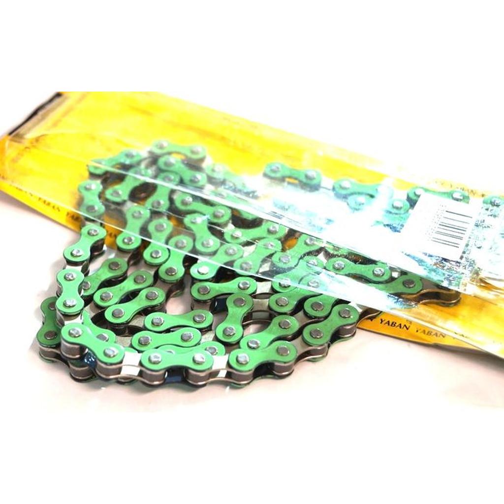 A YBN S-410 Full Link Chain in green and silver, made for single speed bikes, is partly out of its yellow packaging displaying a barcode.