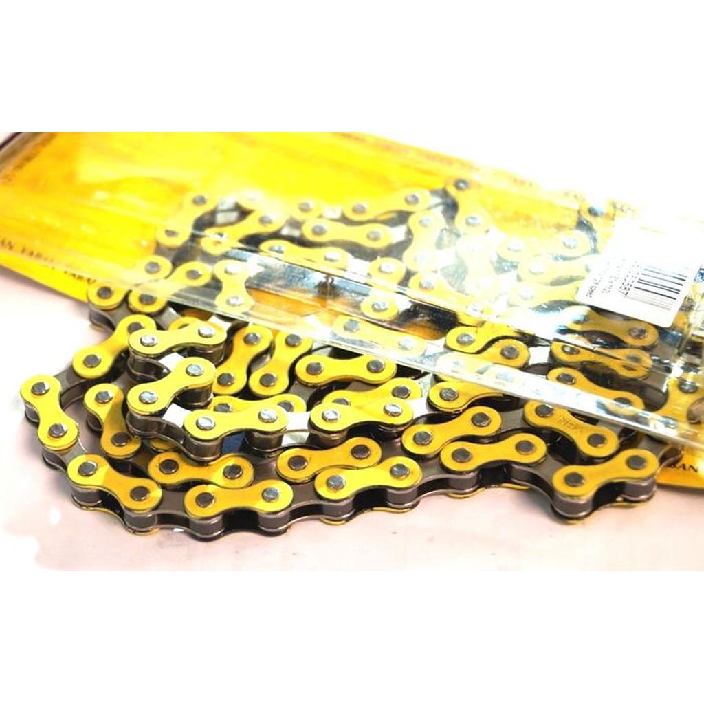 A YBN S-410 Full Link Chain in yellow and silver is partially removed from its clear plastic packaging and displayed on a white surface.
