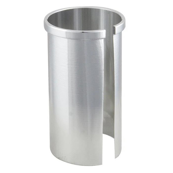 The Seat Post Shim is a cylindrical metal adapter with a vertical slit, designed to fit 22.2mm seatposts into 25.4mm frames by exposing the interior for easy adjustment.