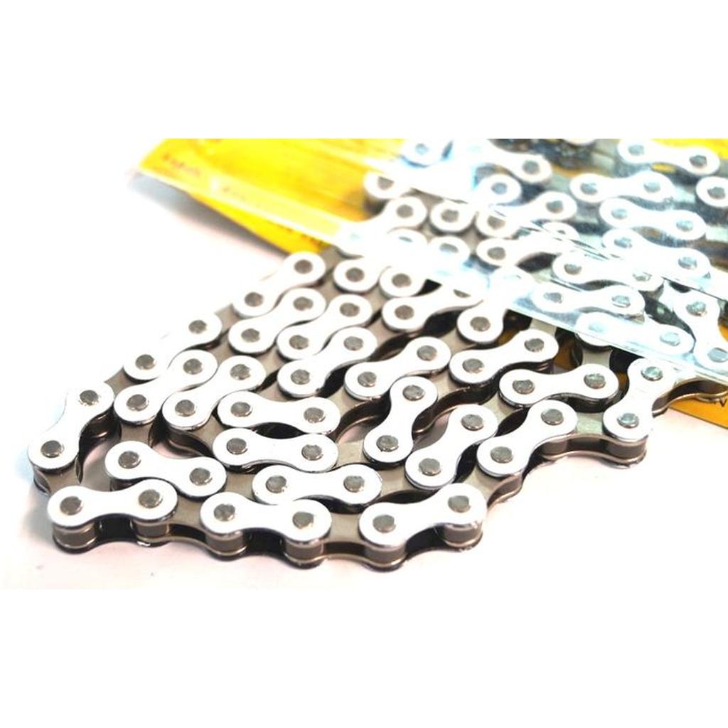 Close-up of the YBN S-410 Full Link Chain on a white surface with part of its yellow packaging visible in the background.