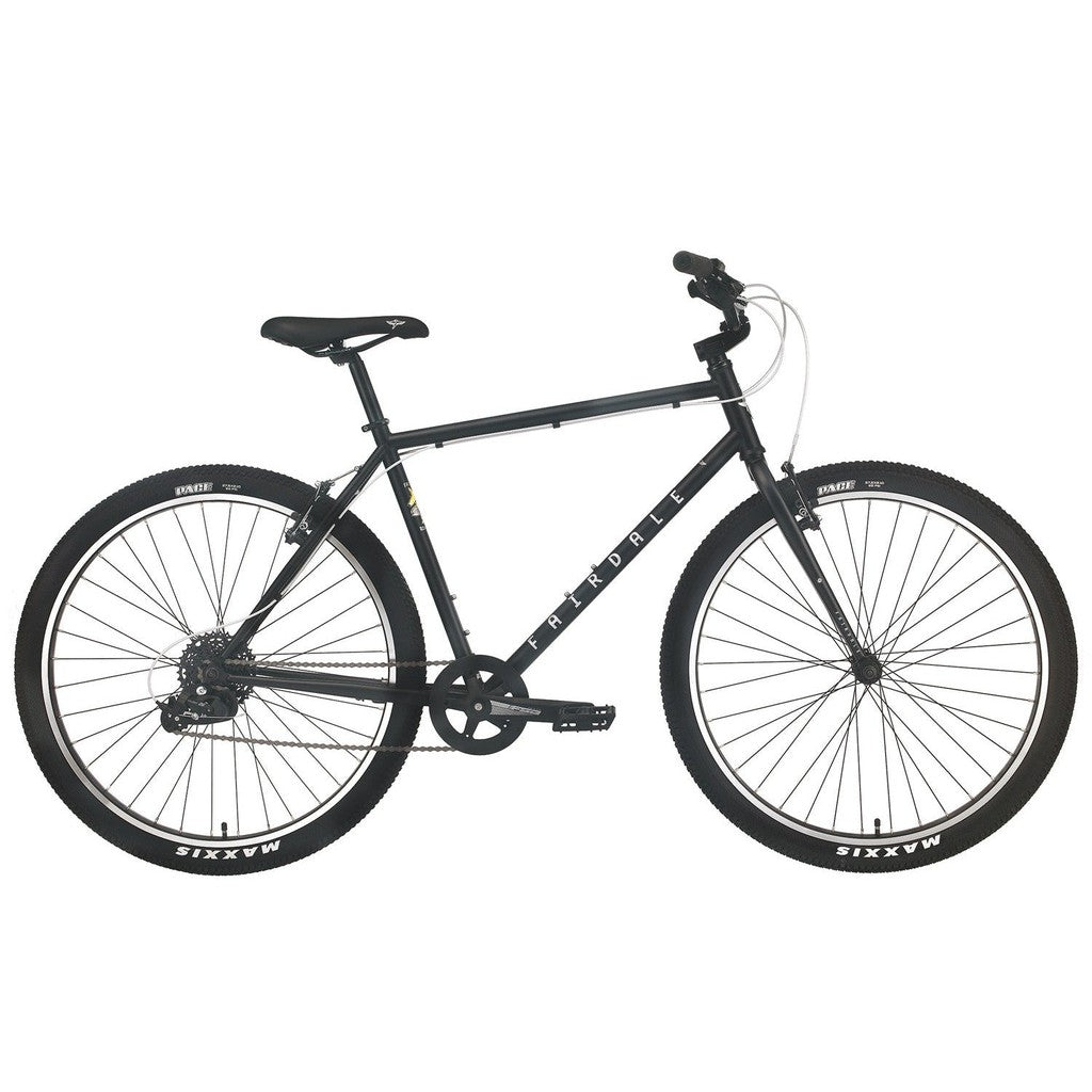 A black single-speed bicycle featuring a sturdy frame, straight handlebars, wire spokes, and Maxxis tires. This minimalist bike offers a straightforward design with no additional accessories, ideal for those who value simplicity. Comparable to the 2023 Fairdale Ridgemont 27.5 Inch Bike but without the complexity of an 8-speed drivetrain.