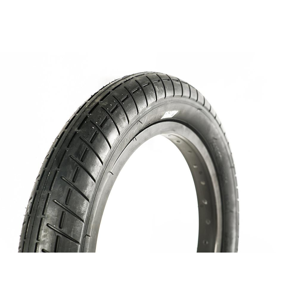 Close-up of a Family F2610 14 Inch Tyre in black with a slick tread pattern, standing upright against a white background.