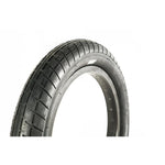Close-up of a Family F2610 14 Inch Tyre in black with a slick tread pattern, standing upright against a white background.