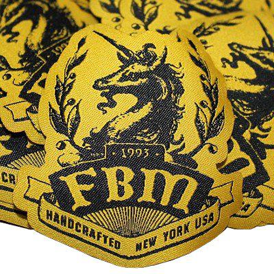 A denim jacket adorned with FBM Woven Unicorn Patch.