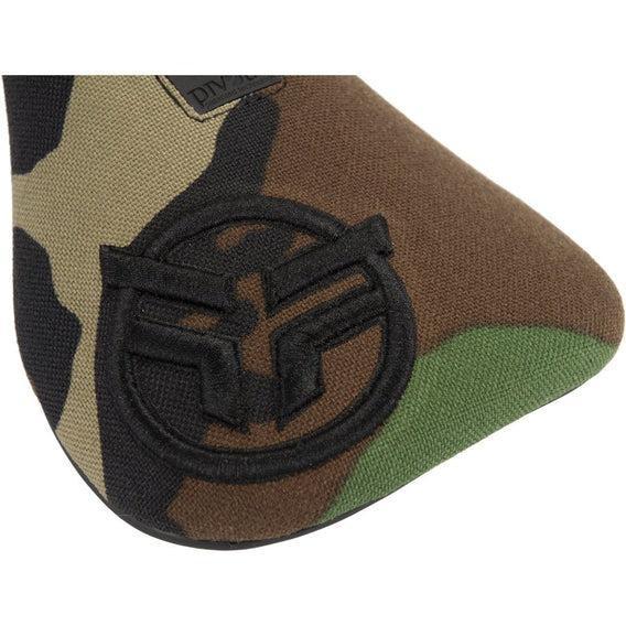 Close-up of the Federal Logo Slim Pivotal Seat in camo, showcasing a raised black stitched circular logo with stylized letters that adds a bold accent to the camouflage fabric.