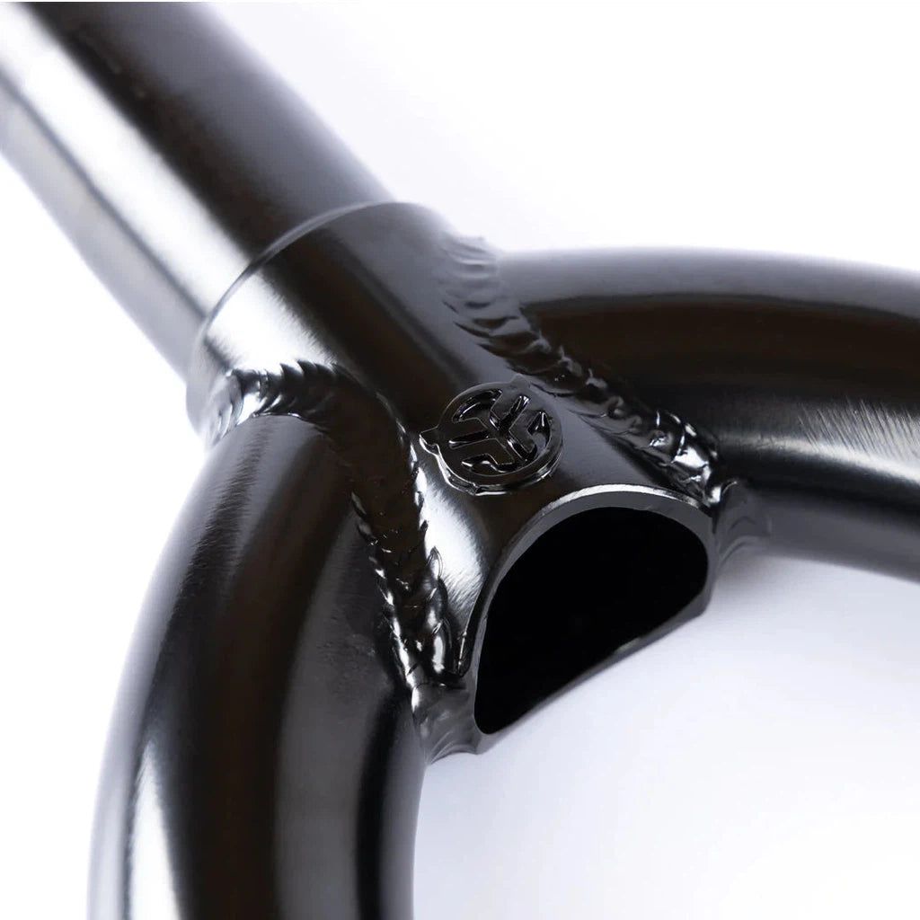 A close up image of a black bicycle handlebar featuring heat-treated Federal Assault 15 Forks material.