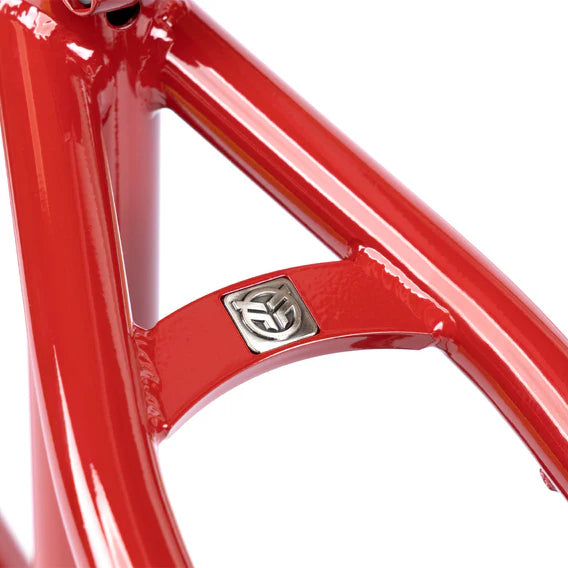 Close-up of the Federal Team ICS2 Frame, built from 4130 Chromoly tubing with a red finish and a silver emblem on the horizontal bar—designed for technical street riding.