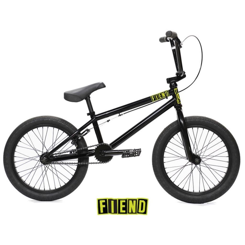 Side view of a black Fiend Type O 18 Inch Bike (2026) with yellow FIEND branding on the chromoly frame and a matching FIEND logo displayed below the bike.