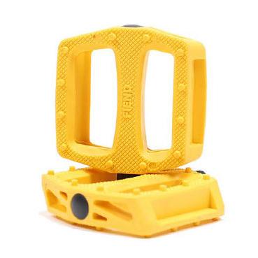 Two yellow rectangular Fiend Reynolds Pedals, made with textured nylon composite bodies and open centers—one upright, one flat—feature durable chromoly spindles for reliable cycling performance.